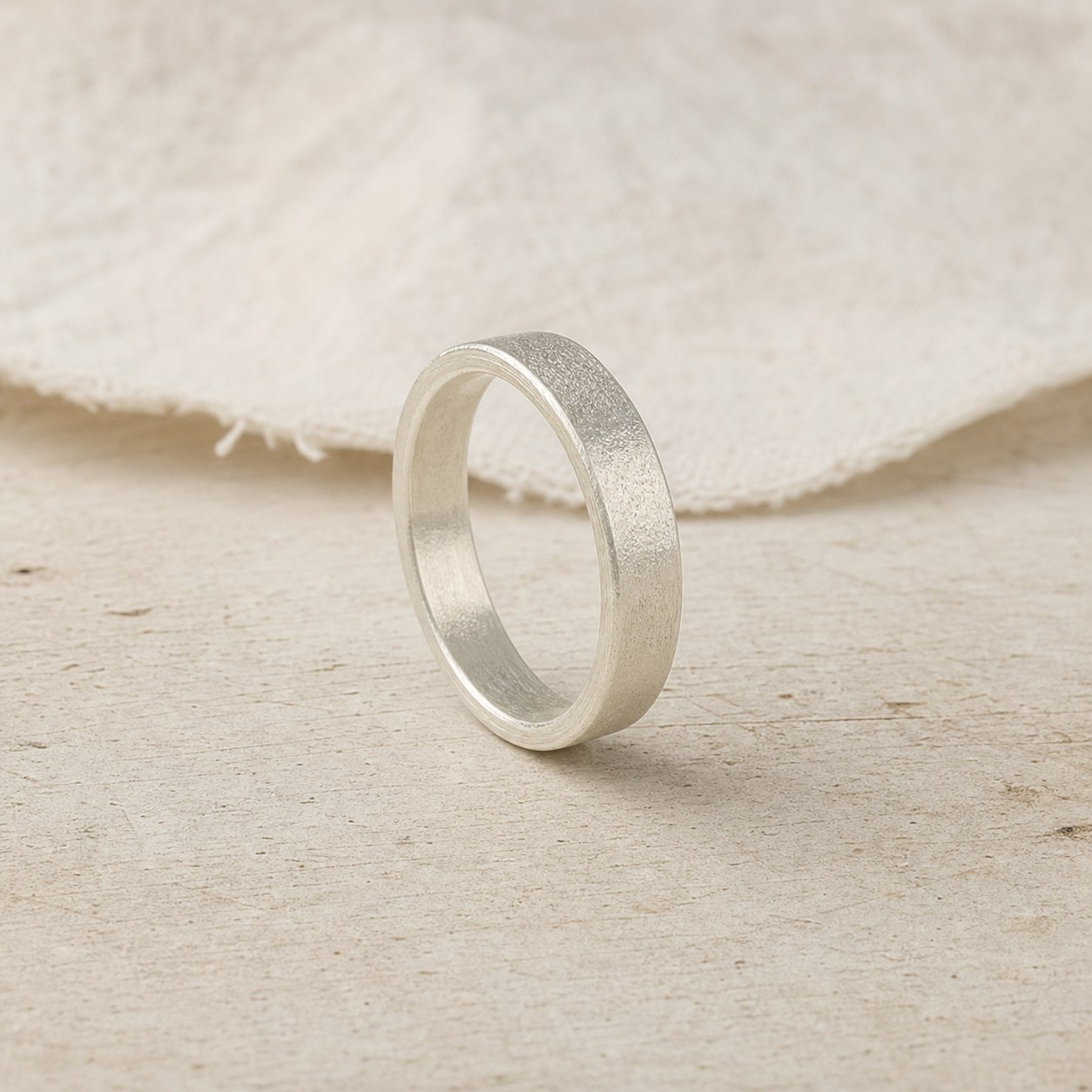 Quiet Texture fine silver band during hand-finishing in the workshop