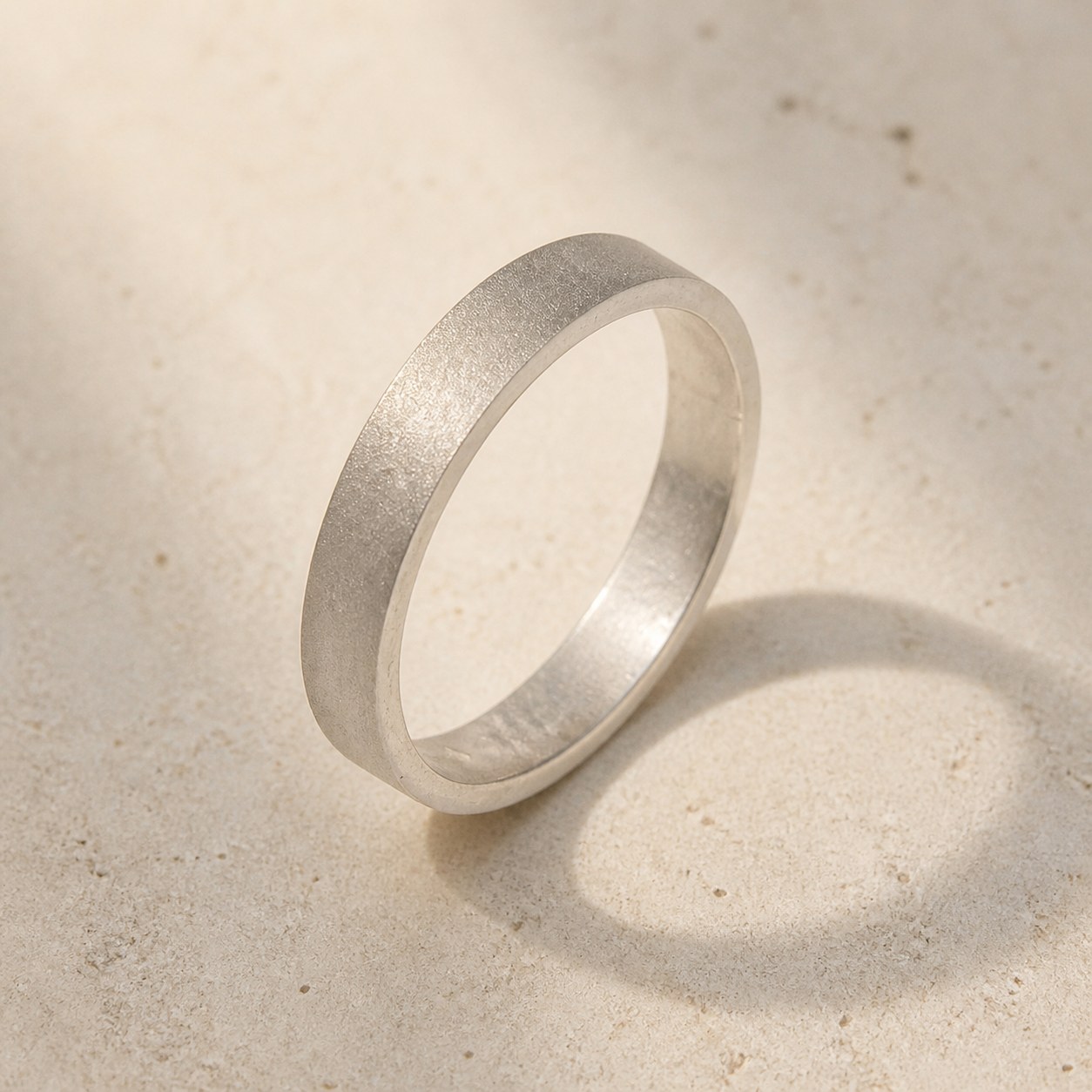 Satin Weight matte 999 fine silver band on a neutral background