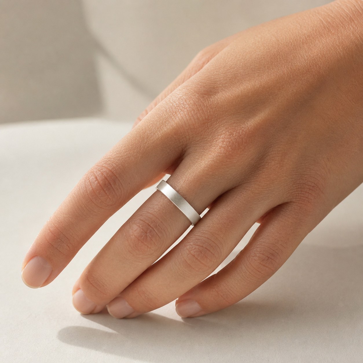 Satin Weight matte fine silver band worn on a hand