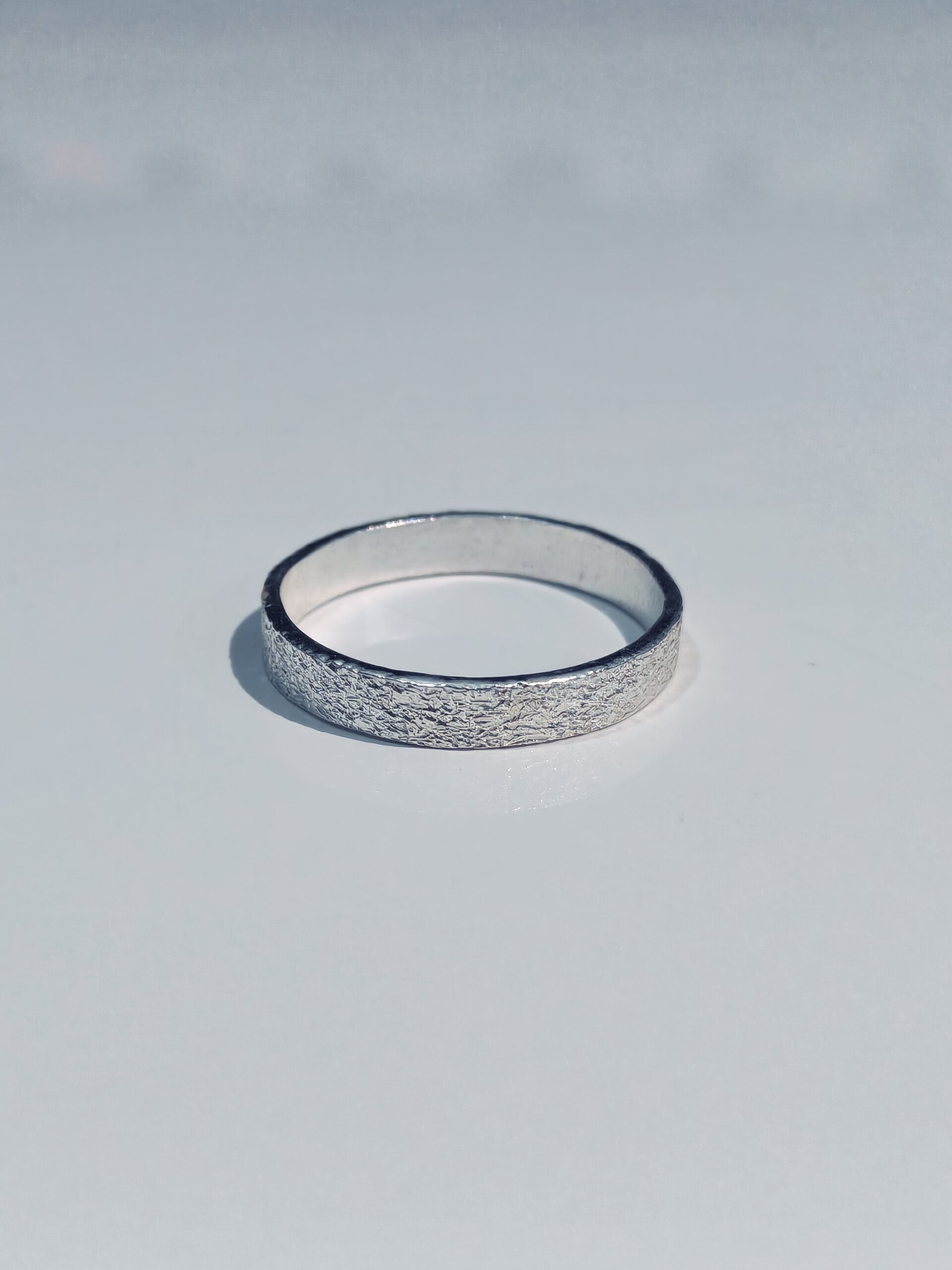 Close view of the granular surface on a 999 fine silver band