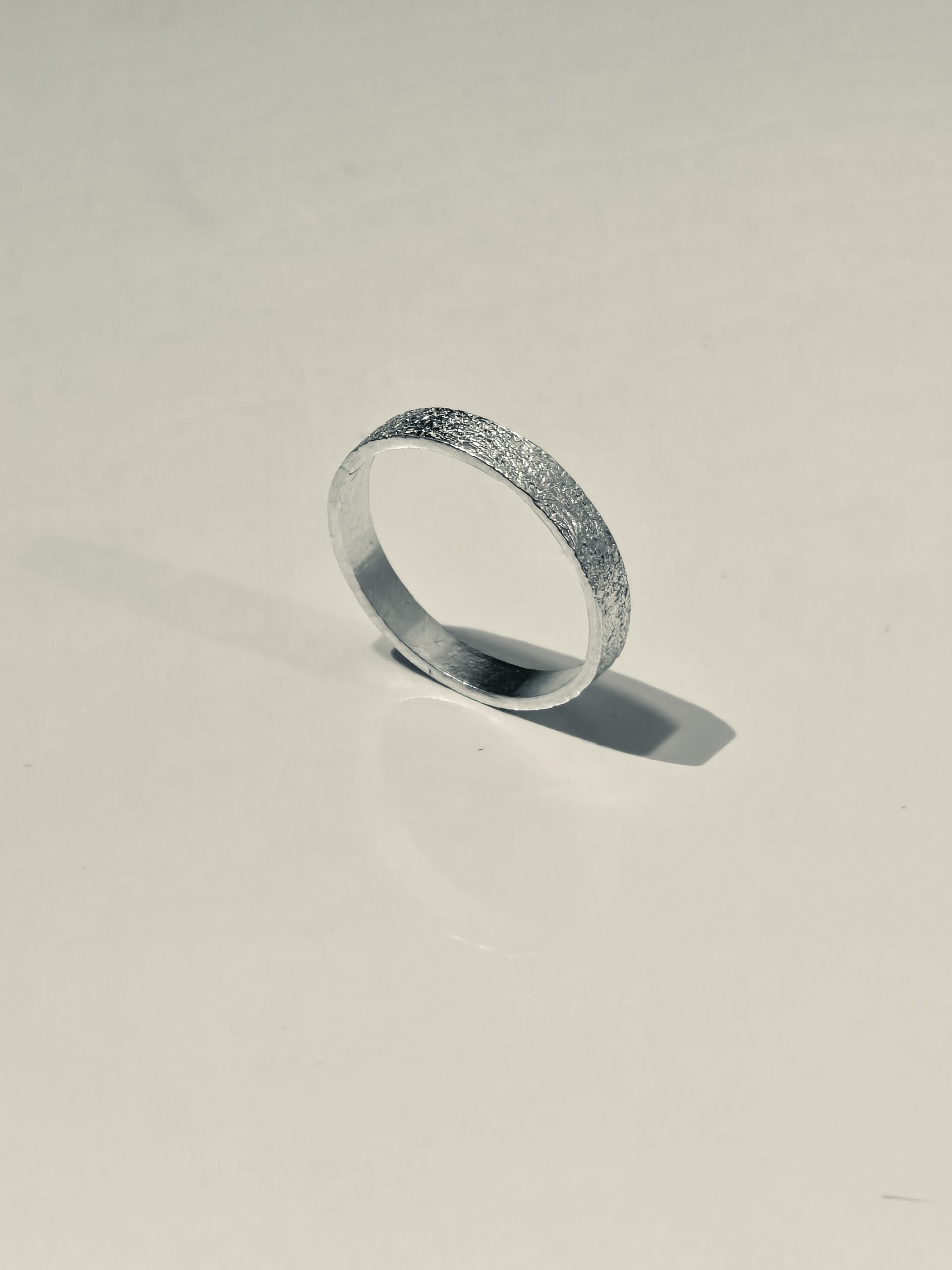 Profile view of a textured 999 fine silver band
